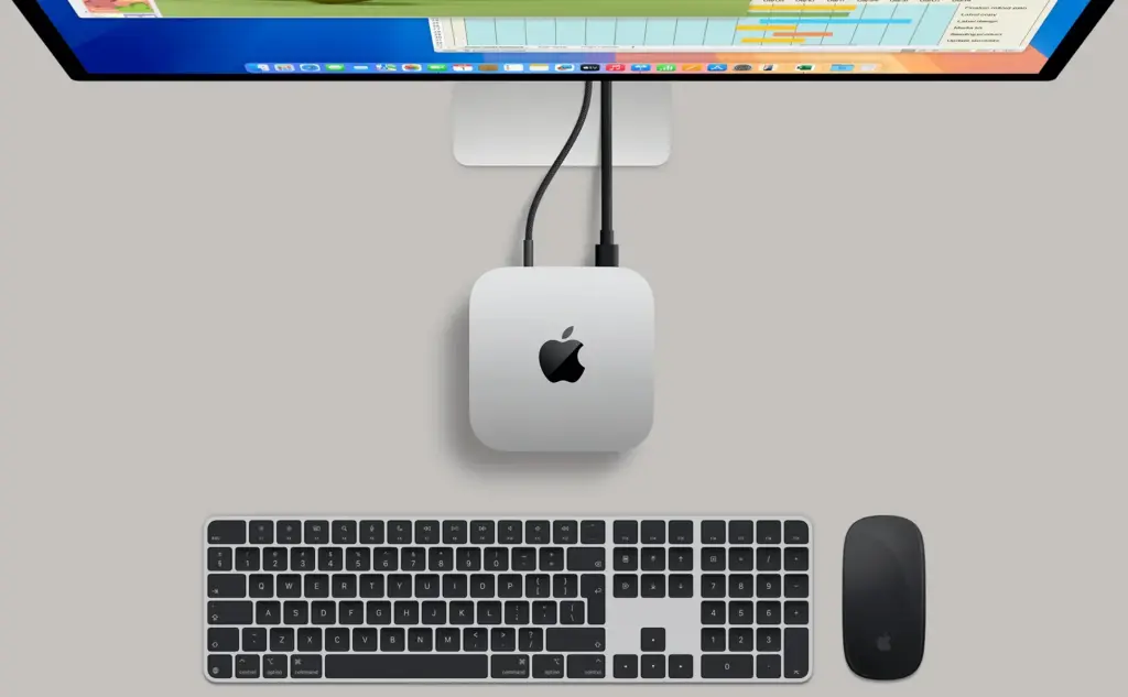 mac mini m4 review 2025 08 10 at 2.25.57 PM Mac Mini M4 desktop setup with display, keyboard, and mouse – compact 5x5-inch footprint